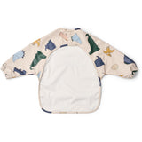 LIEWOOD Dino Roar / Sandy Merle Printed Cape Bib